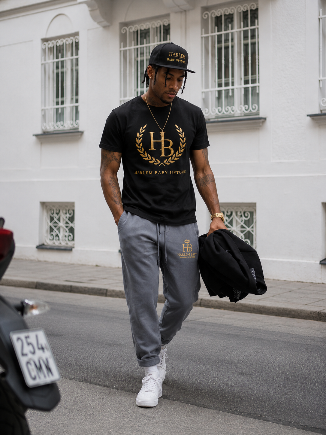 Harlem Baby Uptown crest tee in black with gold laurel and HB monogram